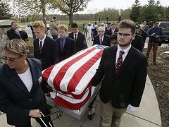 UD Jesuit High students carry caskets of the homeless