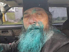 Another priest of the UOC doused with green antiseptic dye