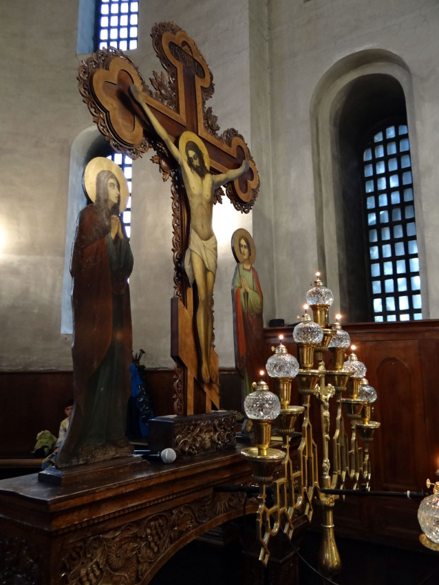 The Crucifixion scene and lamps behind the altar